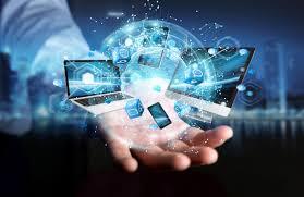 Hand holding digital devices with a globe and network connections.